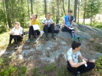 Orienteers wait pensively in the sunshine for the arrival of the Vampire